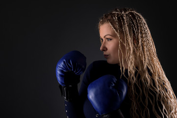 Beautiful blonde girl in boxing gloves. 