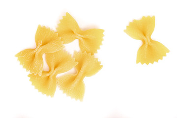Italian raw Pasta Farfalle scattered on a white background. Close up.