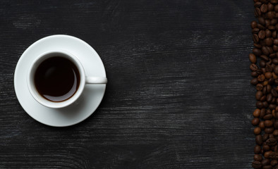 White cup with coffee drink with empty space for text and coffee beans to the right top view