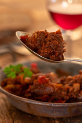 portion of austrian goulash on wood