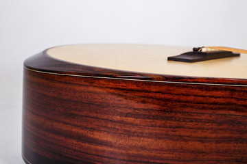 wood texture of lower deck of six strings acoustic guitar on white background. guitar shape