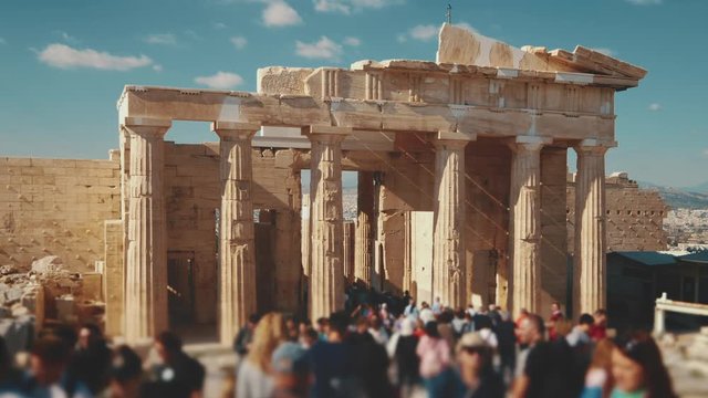 Tourists visiting ancient Greek ruins at the Acropolis in Athens, Greece