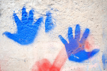 The bright colorful palm prints on the external wall surface.