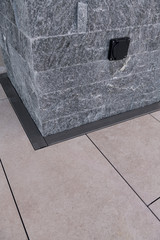 Natural stone facade. Tile floor with metal grille.