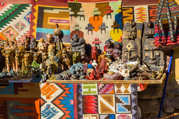 Fototapeta premium Wooden figurines in the store, Ollantaytambo, Peru.