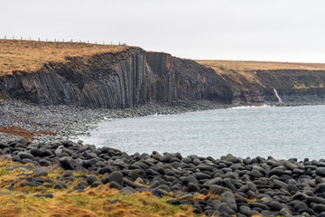 Volcanic rocks or basalt colums in the Kalfshamarsvik area in north western part of Iceland. Pattern, texture and design concept in the icelandic wilderness.