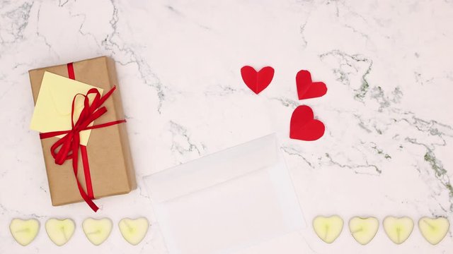 Gift, candles and note for Valentine's day, Mother's day or birthday appear on marble background - Stop motion 