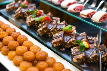 Luxury hotel restaurant deserts open buffet. Table with deserts, Sweet desserts and pastries on the table