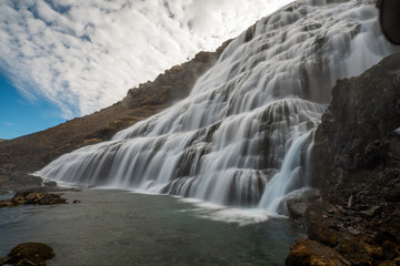 Obraz premium Dynjandi or Fjallfoss big and powerfull waterfall cascade in the westfjords of the Icelandic wilderness during daytime. Waterfalls, traveling and iceland concept.