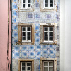 Fototapeta na wymiar the typical decorative tiles on the wall of an old house in the neighborhood of Alfama in Lisbon, Portugal