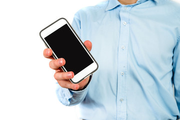 Phone in hand on a white background. A man holds a phone with a blank display in his hand. The concept of supplementing content, providing information.