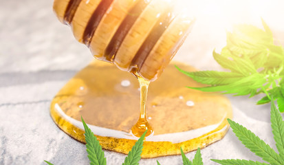 CBD or THC Cannabis Honey on kitchen counter with Hemp leaves