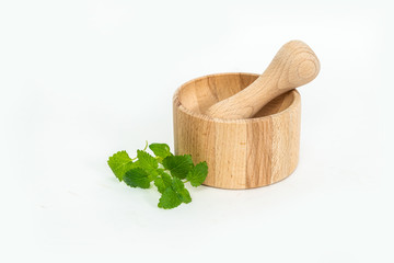 Wooden mortar with herbs Isolated on white background. The concept of crushing and crushing spices,...