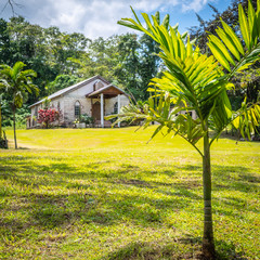Small modest old brick wall chapel, built in 1903, in a Caribbean island countryside. All Saints...