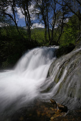 Obraz premium Waterfall on a mountain river in spring.