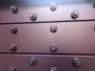 abstract metal background with rivets and screws
