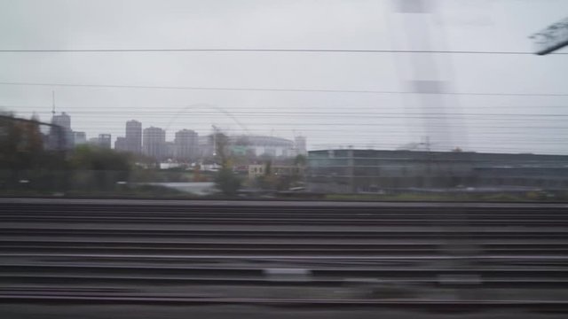 Window view of a train in london with a grey and cloudy weather
