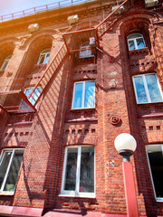 Fototapeta na wymiar red brick building from the end of the 19th century perspective view, blurred image