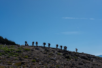Hikers in a line on mountain trail