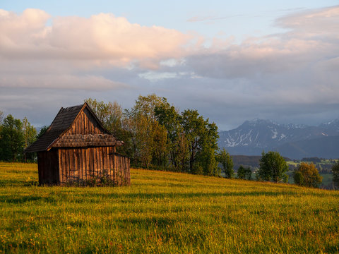 Summer sunrise mountain village outskirts view and Tatra range behind (Zab, Poland)