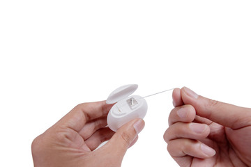 Hand holding dental floss isolated on white background. For polishing teeth