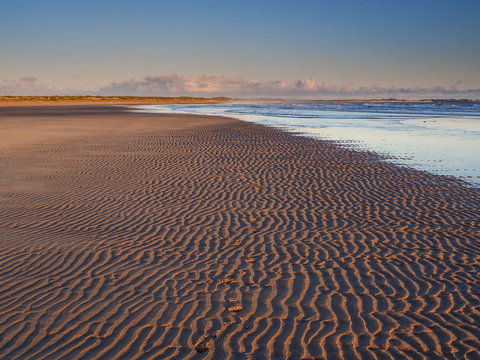 a gloriously wide sandy beach that seems to stretch for miles into the distance and the site of the majestic ruins of Dunstanburgh Castle.