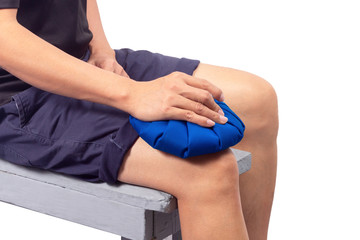 Man hand holding ice pack compress to the knee, relieving pain. isolated on white background.