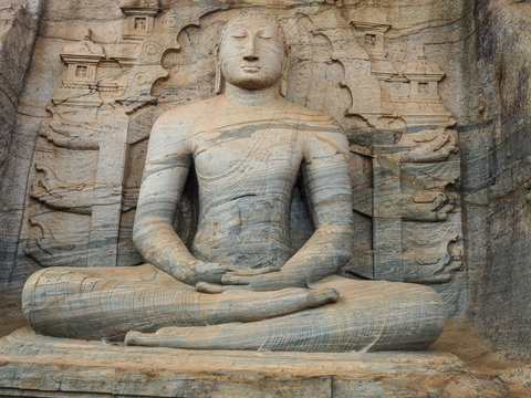 Unique monolith Buddha statue in Polonnaruwa temple and monk  - capital of Ceylon,UNESCO World Heritage Site