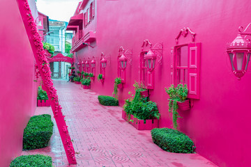 Pink street with green plants, windows, street lams, decorative caribbean entourage in old city victorian style, Puerto plata, Dominican Republic, Paseo de doña Blanca