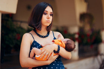 Stressed Young Mother Calming Her Baby 