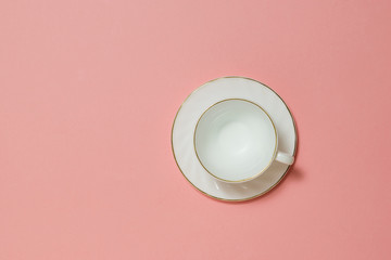 White ceramic coffee Cup on pink background.