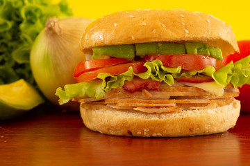 Front view smoke turkey hamburger whit a ingredients, yellow background. fast food marketing concept.