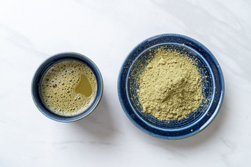 hot matcha green tea cup with green tea powder and whisk