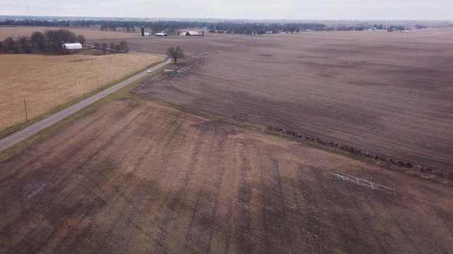 Aerial fly over view of harvested fields in rural Illinois