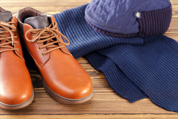 Men's casual outfits on wooden surface.