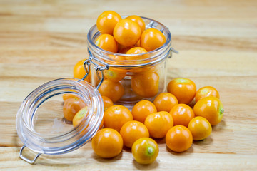 Cape Gooseberry in glass cup on wood table