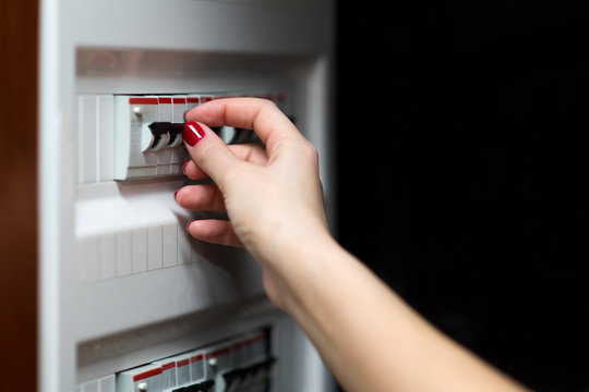 girl is going to turn off the electricity in the house