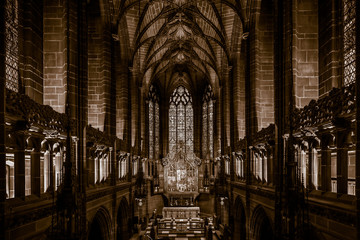 Naklejka premium LIVERPOOL, ENGLAND, DECEMBER 27, 2018: The Lady Chapel in Liverpool Anglican Cathedral. Perspective view of a magnificent part inside the church, where light meets darkness all along place.
