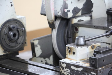 Deadhead draw chuck and grinding disk on turning lathe grinder machine tool on spindle headstock background, industrial metal working