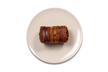 Chocolate roll bread in plate isolated on white background