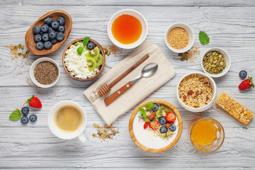 Healthy breakfast set with yogurt, berries, coffee and granola. Top view. Flat lay