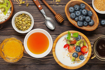 Healthy breakfast set with yogurt, berries, coffee and granola. Top view. Flat lay