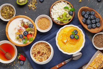 Healthy breakfast set with corn porridge, yogurt, berries, coffee and granola. Top view. Flat lay