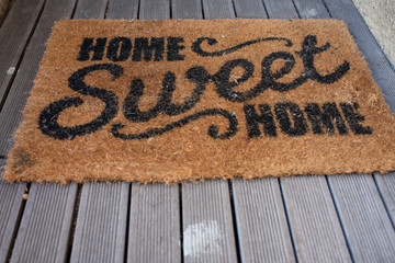 Welcome mat reading home sweet home