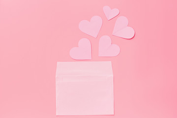 Valentine's day background. greeting card with pink hearth in envelope. Flat lay, top view, mockup, template, copy space. Minimal abstract composition for 14 February celebration