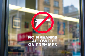 No firearms allowed on premises sign on the glass entrance door to establishment notifies patrons...