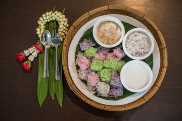 Colorful Thai Desserts (Ka-Nhom-Ray-Rai or Rang-rai ) Rice flour dumpling topped coconut milk and sugar mixed with sesame (Thailand traditional food)