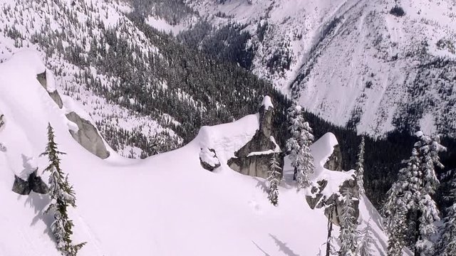 Drone Dolly Vertigo Zoom of Snowy Backcountry Mountain Peaks Boomerang