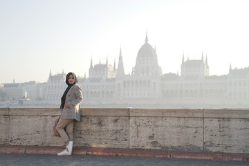 a model posing against a background and beautiful city buildings of budapes