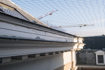 A woven net for birds to keep away from buildings